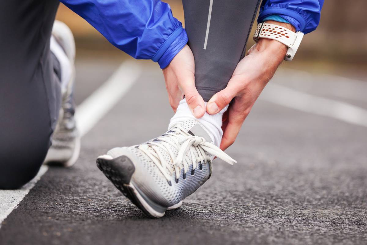 Stock Image of Model Ankle Pain while Exercising